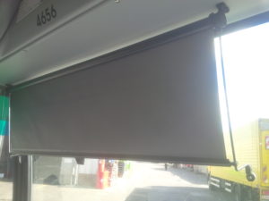 manual guided rollerblind on a city bus  windshield
